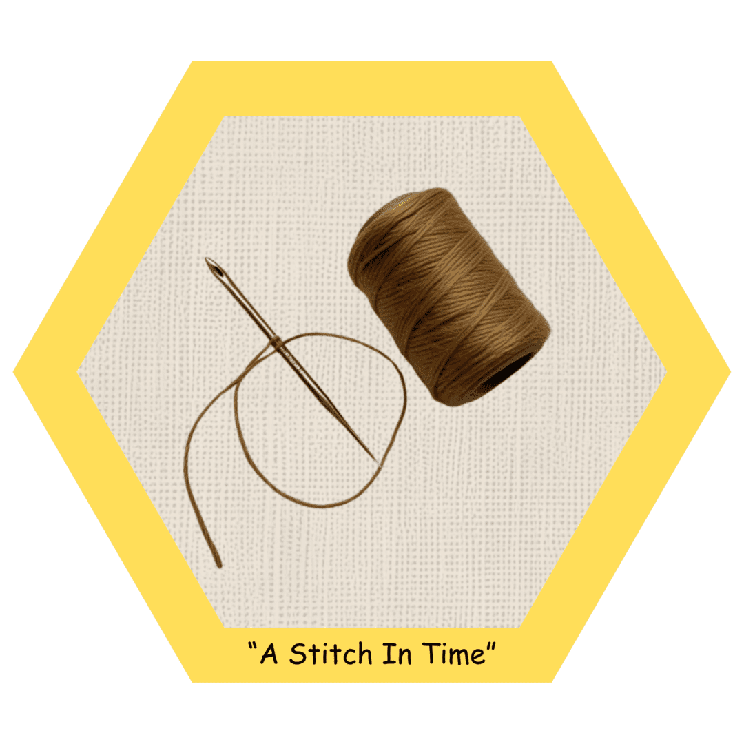 Needle and thread on woven fabric background.